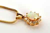 Lot 832 - An opal and diamond cluster pendant, the oval...