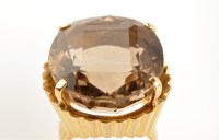 Lot 841 - A single stone quartz ring, the brown quartz...