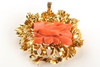 Lot 846 - A carved coral and yellow metal brooch/pendant,...