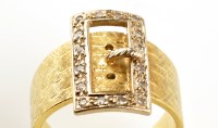 Lot 848 - A diamond buckle pattern ring, the diamonds...