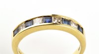 Lot 854 - A sapphire and diamond half hoop eternity ring,...