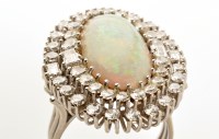 Lot 865 - An opal and diamond cluster ring, the central...