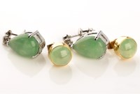 Lot 874 - A pair of jadeite stud earrings, each with...