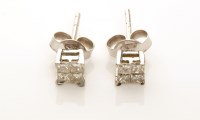 Lot 875 - A pair of diamond stud earrings, each set with...