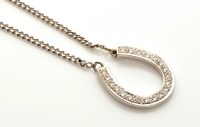 Lot 876 - A diamond set horseshoe pattern pendant, the...