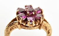 Lot 880 - A ruby cluster ring, with central circular...