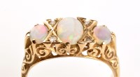 Lot 881 - An opal and diamond ring, the three tapering...