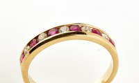 Lot 886 - A ruby and diamond half hoop eternity ring,...