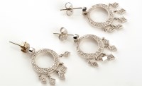 Lot 891 - A pair of diamond drop earrings, the graduated...