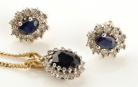 Lot 892 - A sapphire and diamond cluster pendant, the...