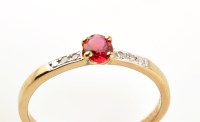 Lot 903 - A ruby and diamond ring, the single oval facet...