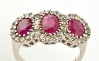 Lot 908 - A ruby and diamond triple cluster ring, the...