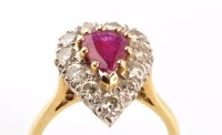 Lot 917 - A ruby and diamond cluster ring, the pear cut...