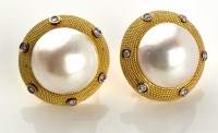 Lot 918 - A pair of mabe pearl, diamond and 18ct. yellow...