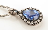 Lot 919 - A tanzanite and diamond pendant, the central...