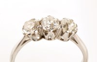 Lot 925 - A three stone diamond ring, the old cut...