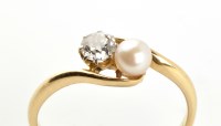 Lot 943 - A diamond and cultured pearl ring, the...