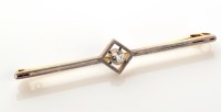 Lot 946 - A diamond set bar brooch, set to the centre...