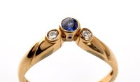 Lot 951 - A sapphire and diamond ring, the circular...