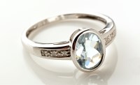 Lot 955 - An aquamarine and diamond ring, the oval facet...