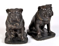 Lot 1019 - A pair of composition stone bulldogs, each...