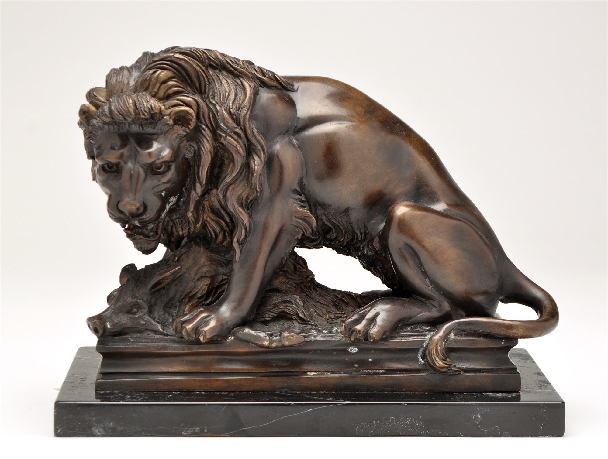 Lot 1028 - A 20th Century cast bronze group of a lion