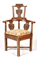 Lot 1165 - A late 18th Century carved oak corner chair,...