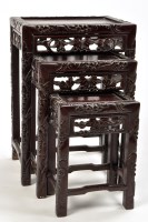 Lot 1170 - An early 20th Century nest of three carved...