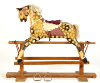 Lot 1175 - A mid-20th Century carved wood rocking horse,...