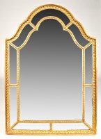 Lot 1201 - A gilt framed wall mirror, with shaped arched...