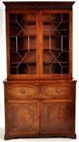 Lot 1243 - A Georgian mahogany secretaire bookcase, the...