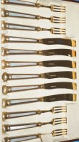 Lot 518 - Six late Victorian silver gilt cake knives and...