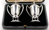 Lot 523 - A pair of Edwardian three-handled pepperettes,...