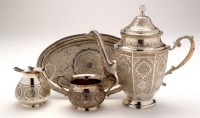 Lot 588 - Four pieces of Persian white metal coffee ware,...