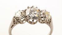 Lot 655 - A three stone diamond ring, the central old...