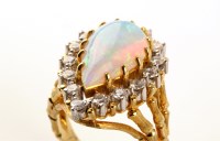 Lot 663 - An opal and diamond cluster ring, the central...