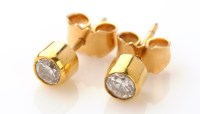 Lot 671 - A pair of diamond stud earrings, each set a...