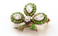 Lot 672 - A diamond and demantoid garnet brooch, of...