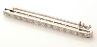 Lot 673 - A diamond bar brooch, set with fourteen...