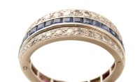 Lot 681 - A sapphire, ruby and diamond eternity ring,...