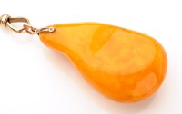 Lot 694 - An amber pendant, the honey coloured free form...