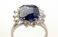 Lot 695 - A sapphire and diamond cluster ring, the...