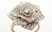 Lot 699 - Piaget: a diamond rose pattern ring, set...