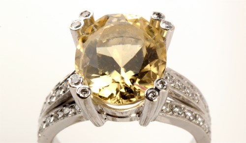 Lot 700 - A citron feldspar and diamond ring, the oval...