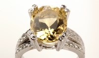 Lot 700 - A citron feldspar and diamond ring, the oval...