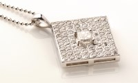 Lot 701 - A diamond pendant, the central princess cut...