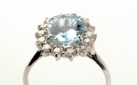 Lot 703 - An aquamarine diamond cluster ring, the oval...