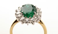 Lot 706 - An emerald and diamond cluster ring, the...