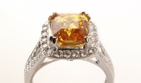 Lot 707 - A yellow sapphire and diamond cluster ring,...