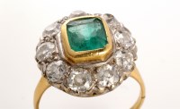 Lot 709 - An emerald and diamond cluster ring, the...